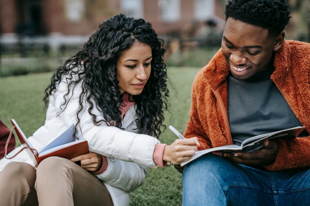 Two students studying together outdoors